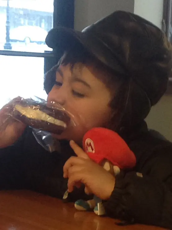 Young customer enjoying a doughnut