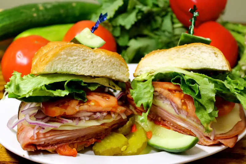 Loaded deli sandwich with lettuce, tomato and pickles